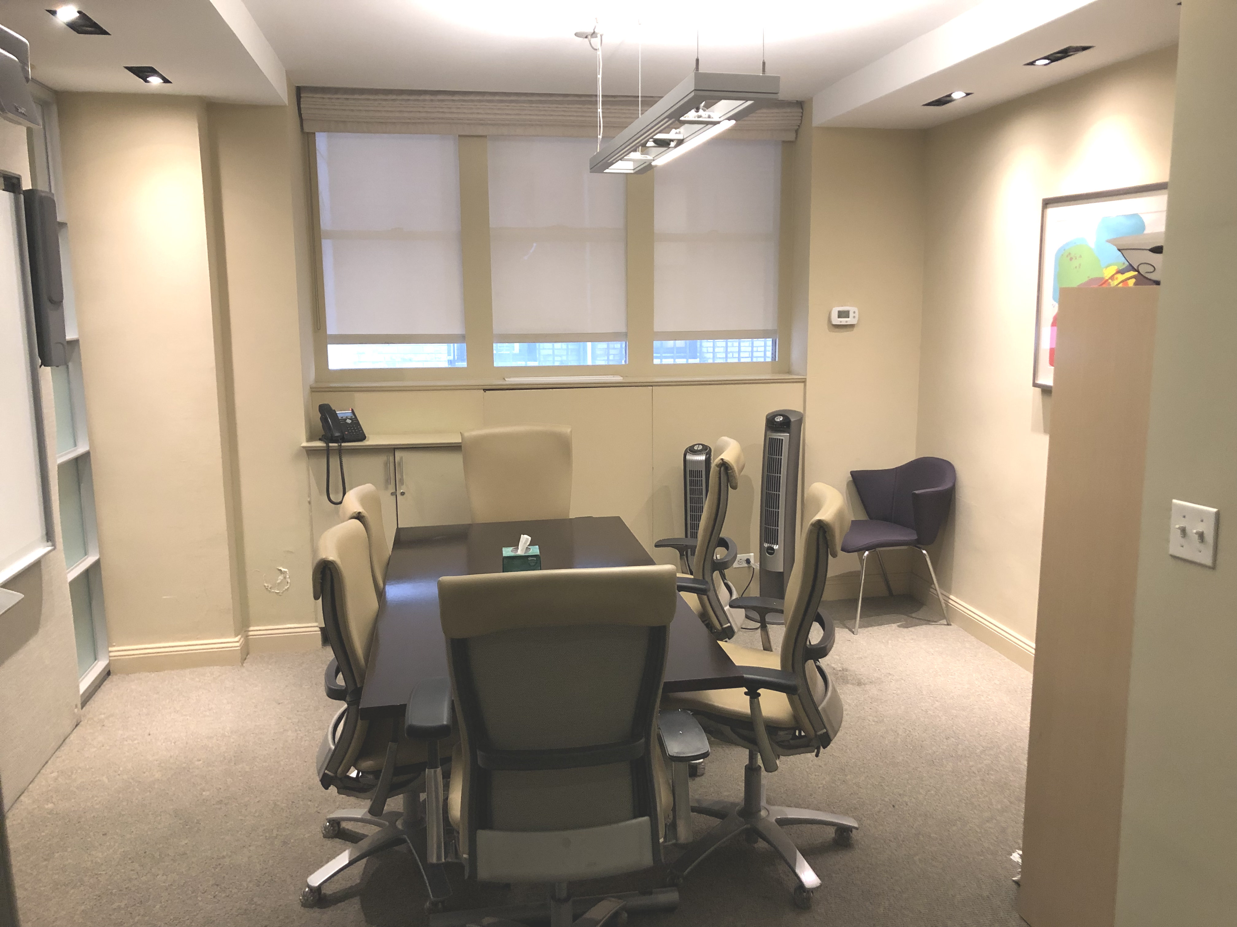 Bright office with chairs, paintings, and professional furniture